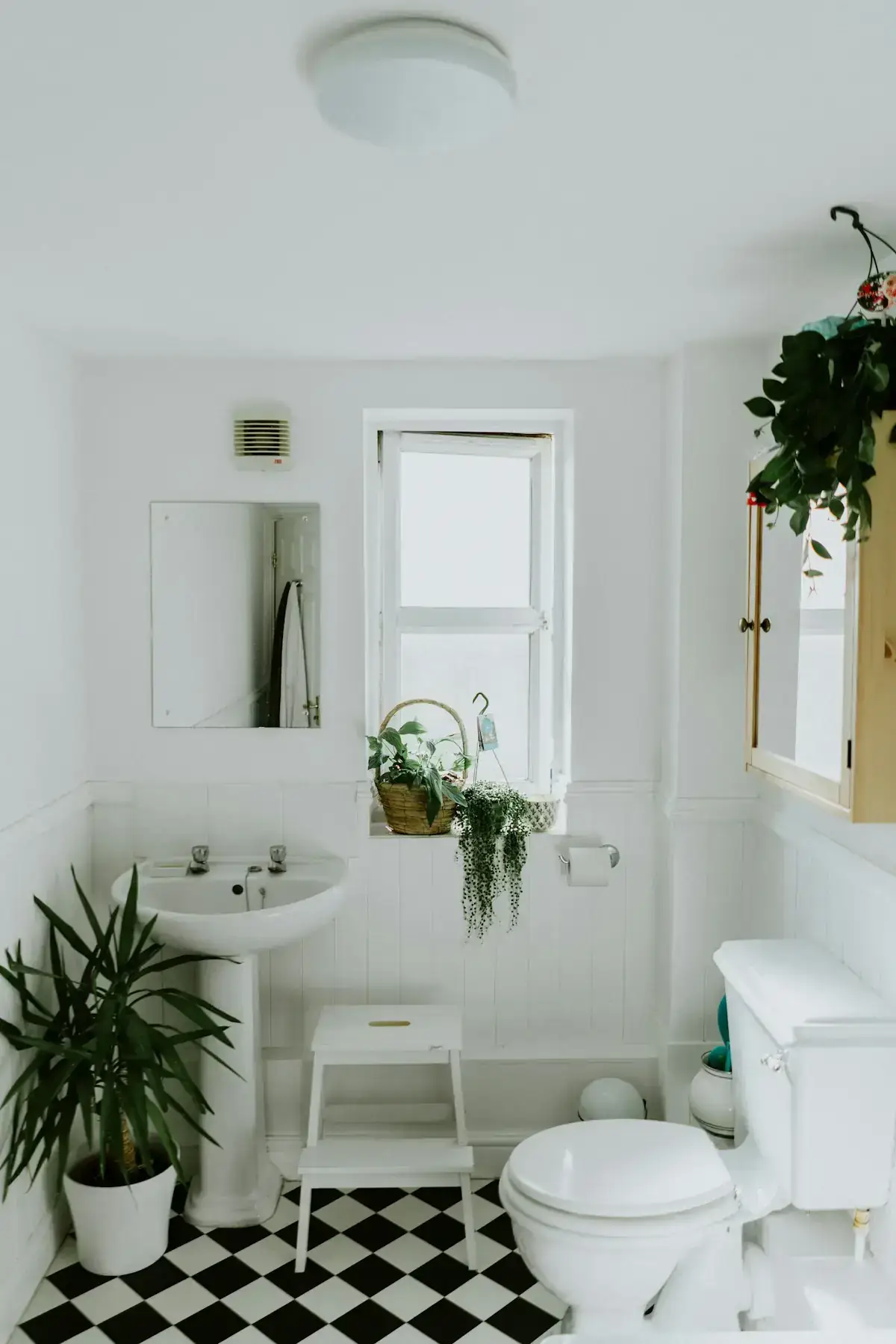 White bathroom with a sink and a window